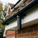 63mm Diameter Gutter Outlet Spigot Extender — Textured Black (in use)