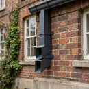 72x72mm Flush Joint Aluminium Downpipe Shoe — RAL 7021 (in use)